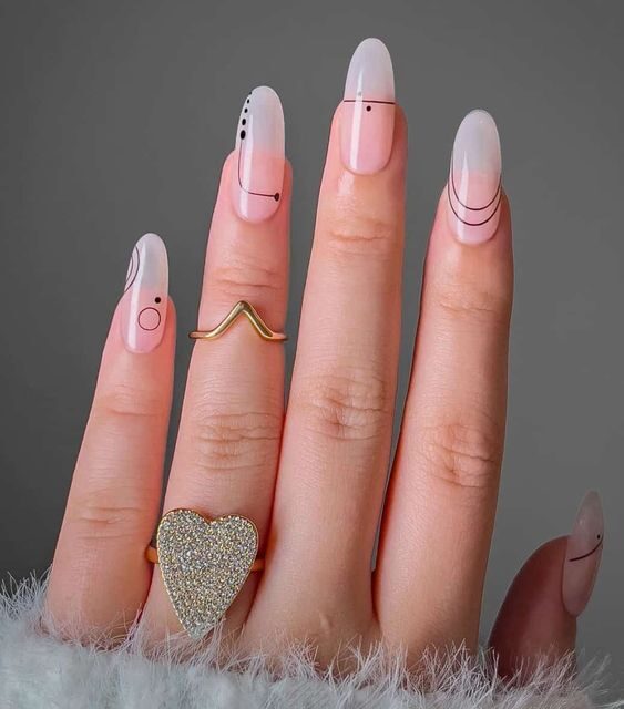 Long round shaped clear nails with abstract nail design