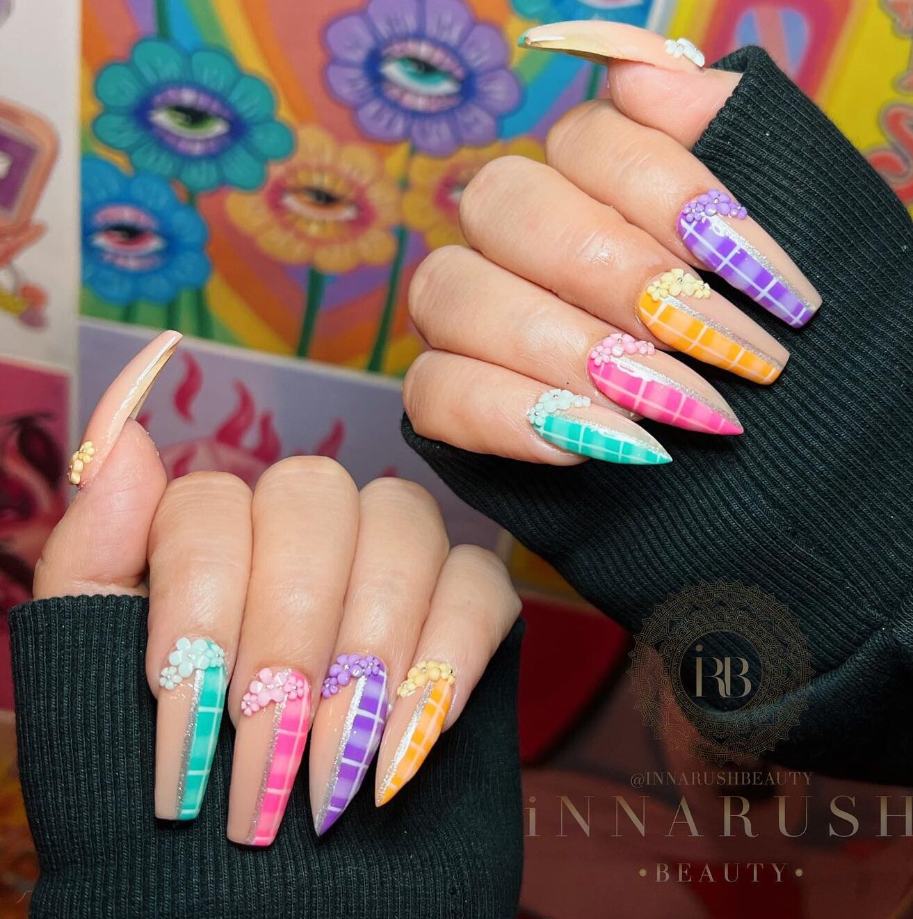 Multicolored checkered nail art with 3D flowers on long stiletto and coffin nails