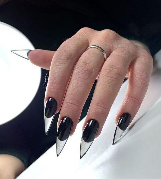 Black nail polish and clear French tips on long stiletto nails