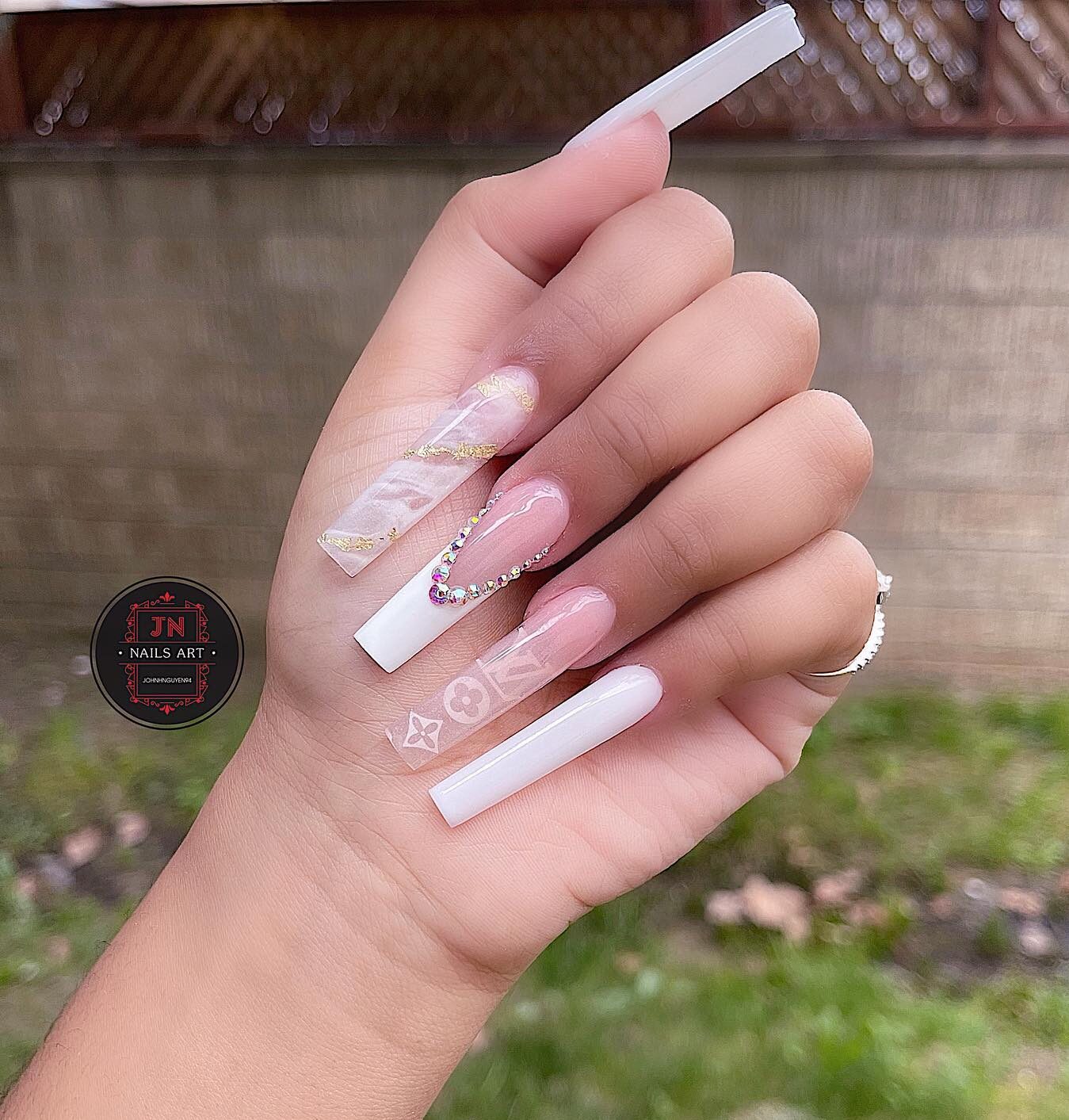 Clear and white nail colors with rhinestones and marble nail arts