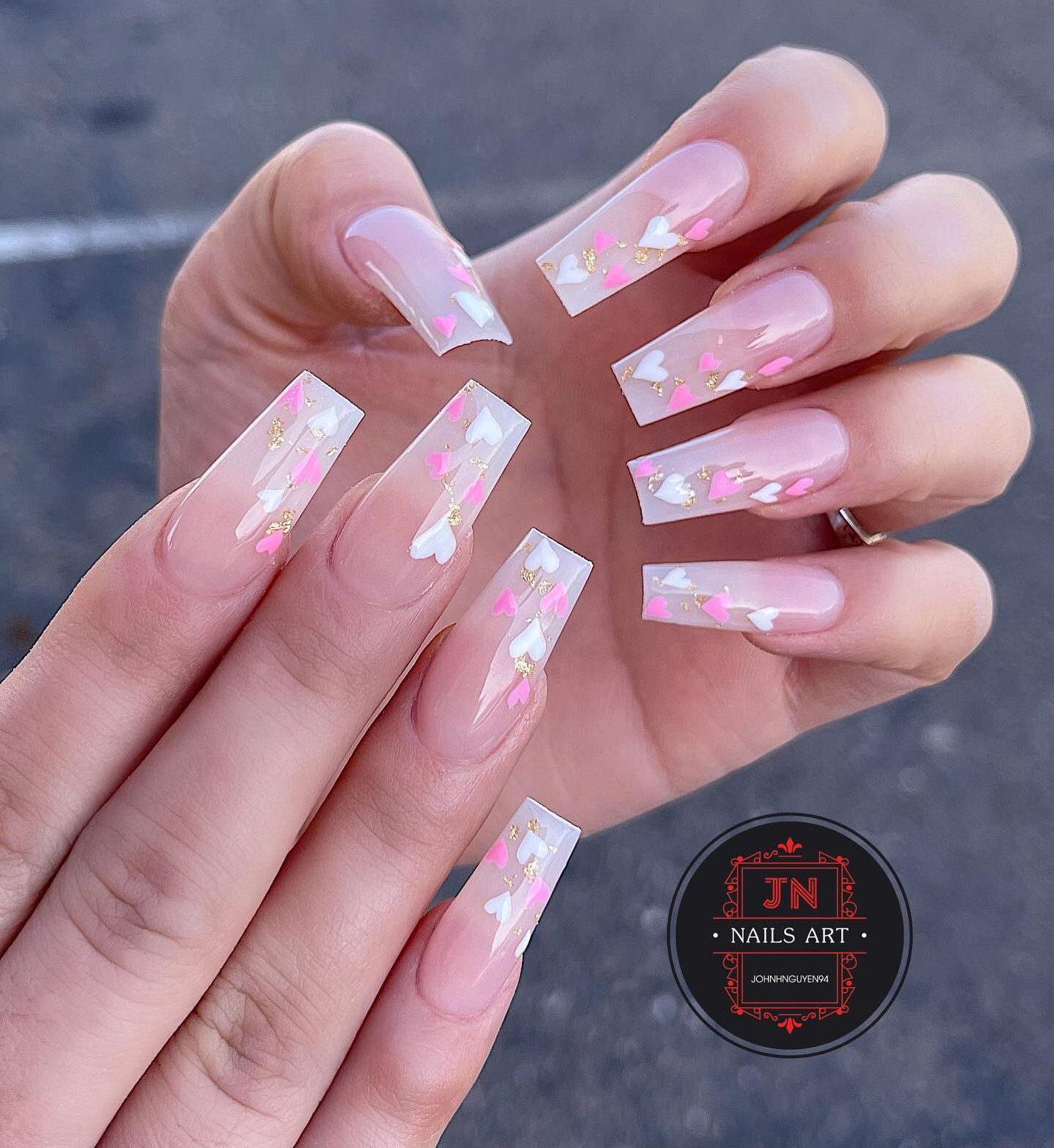 Long tapered square clear nails with white and pink hearts nail designs