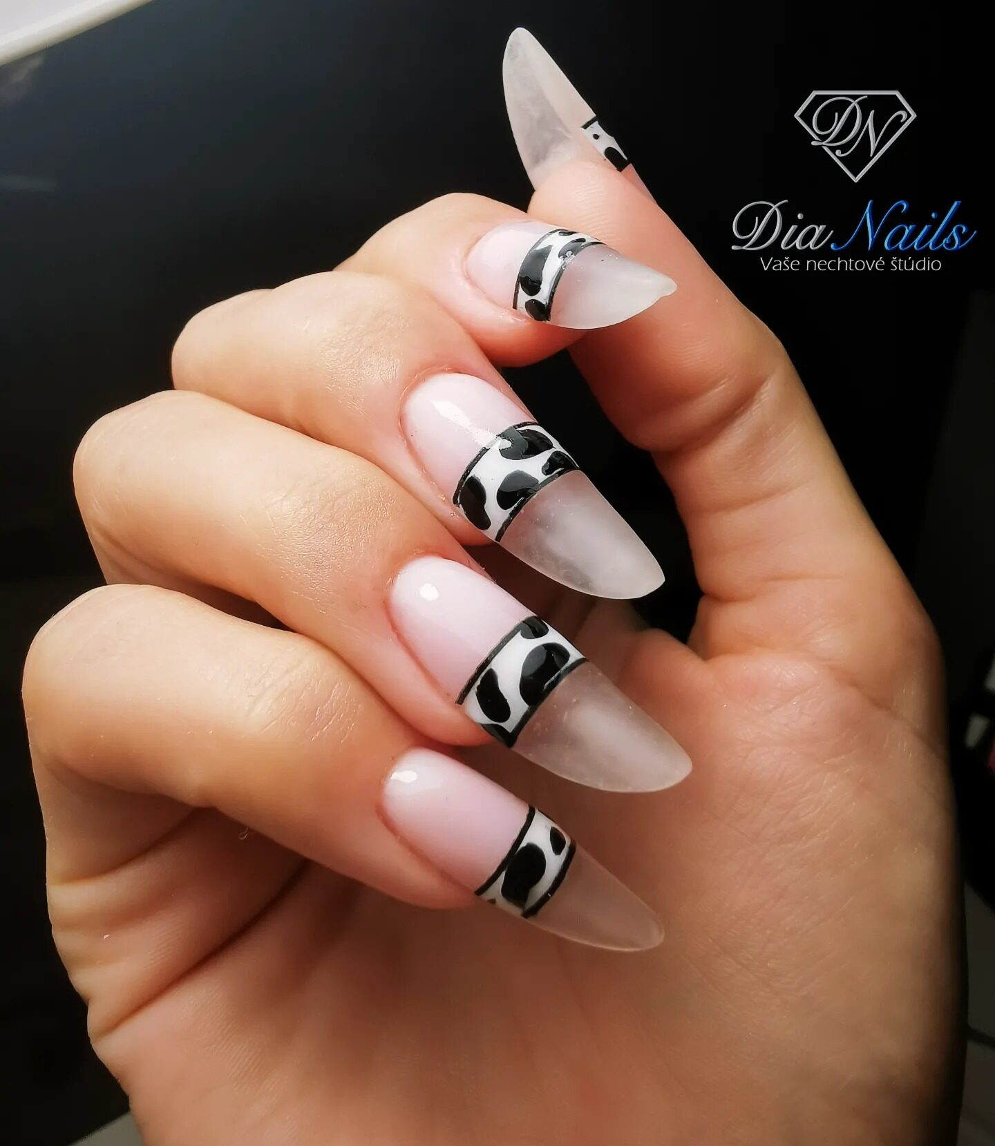 Long round shaped clear nails with cow print nail art