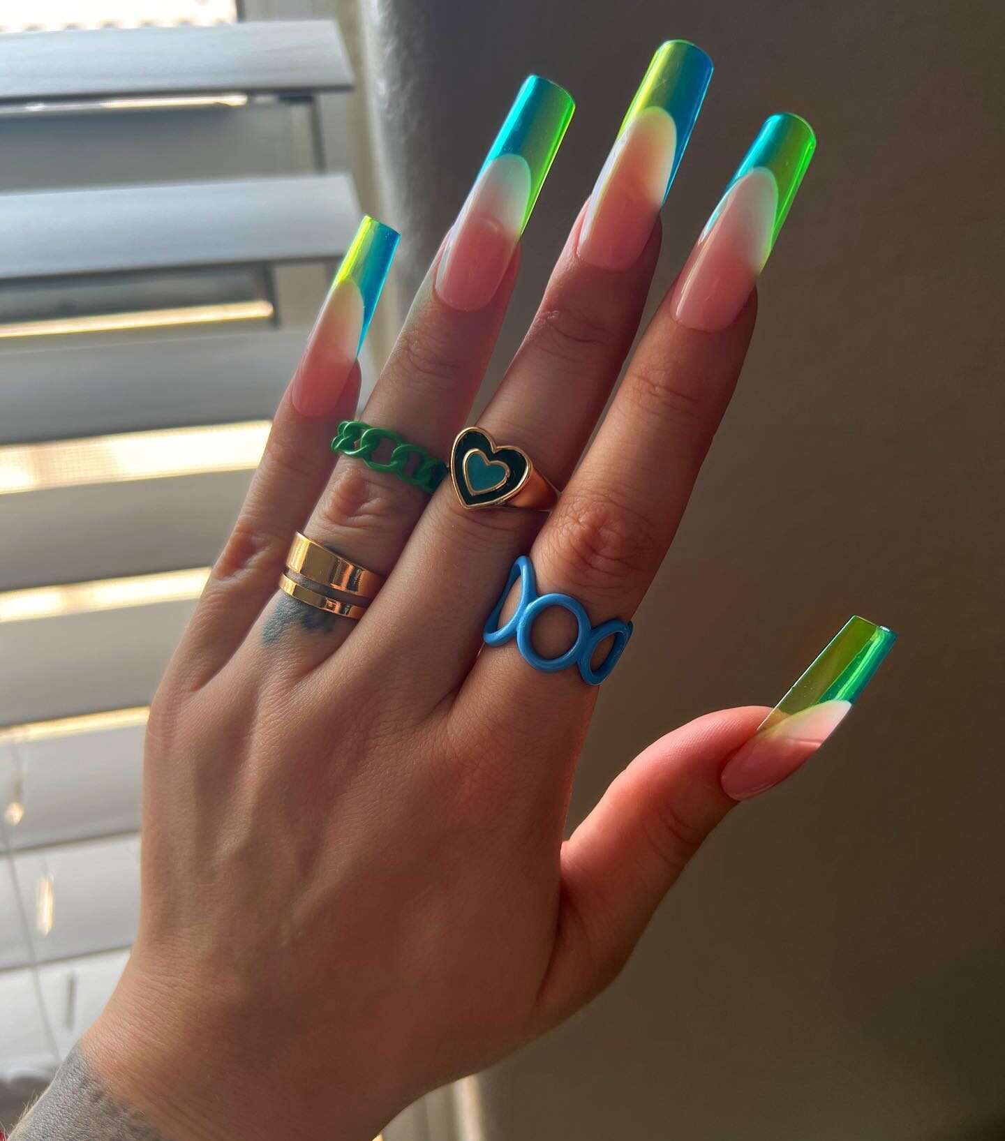 Super long square shaped clear nails with blue and green French tips