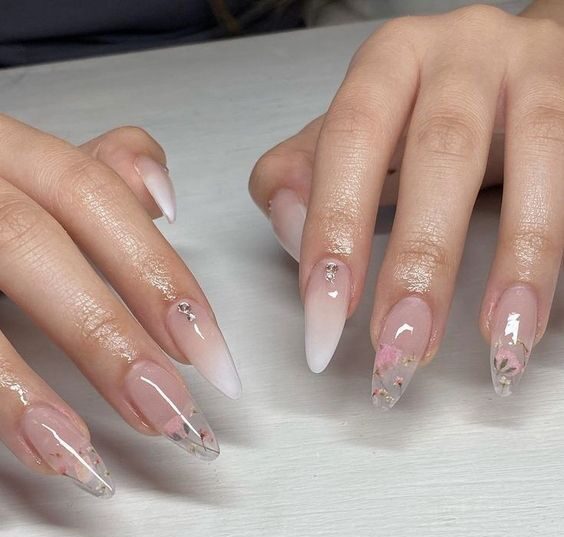 Almond shaped clear nails with flowers and rhinestones nail designs