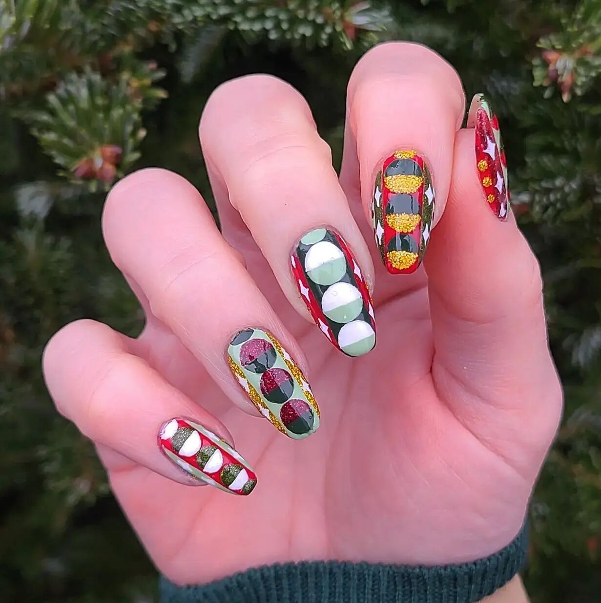 Multicolored geometric pattern with glitters on long almond nails