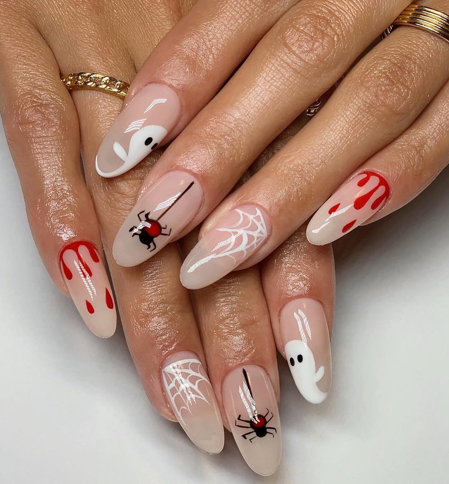 Clear round nails with Halloween-inspired nail designs