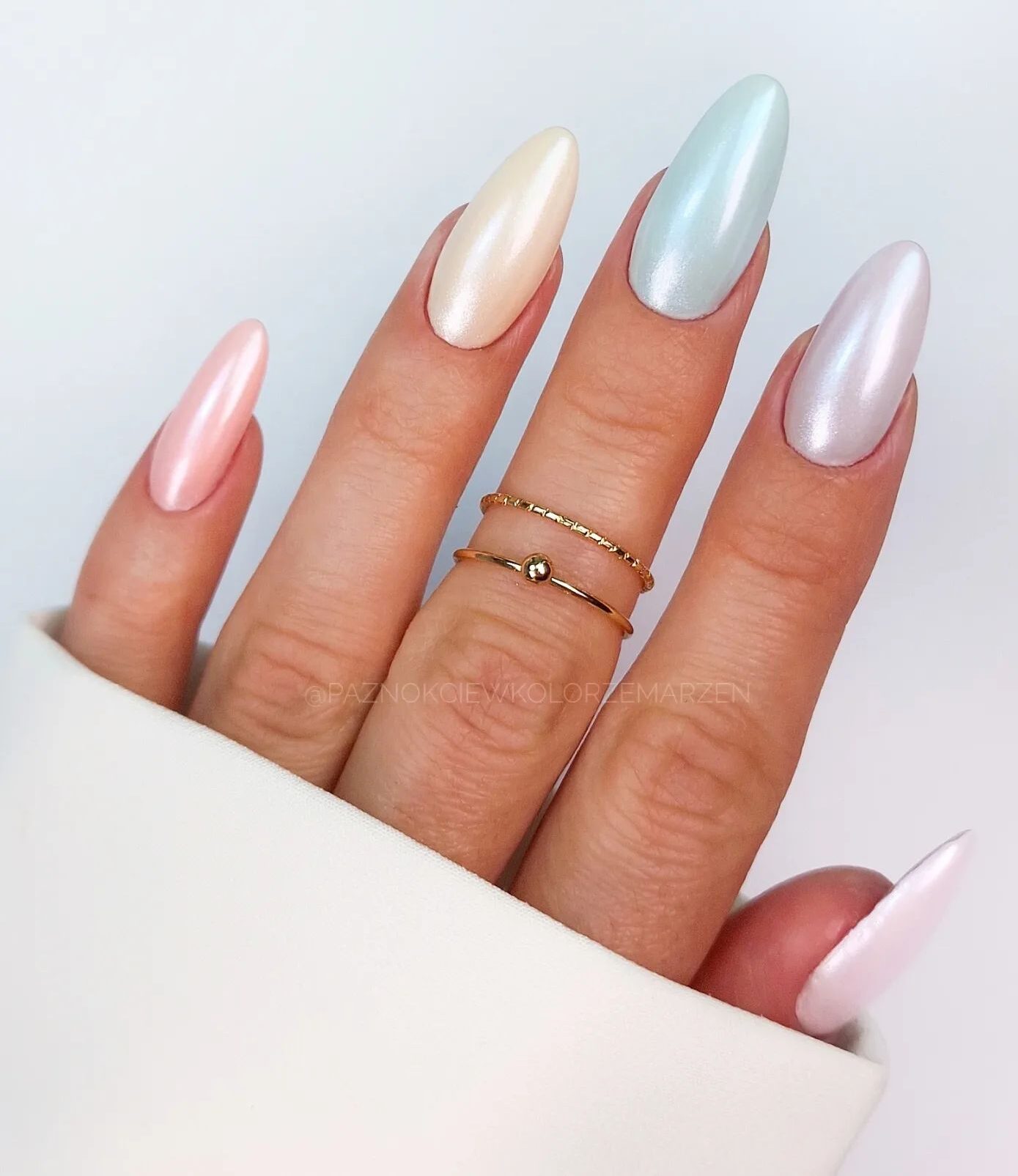 Glossy pastel colors nail polish on long almond nails