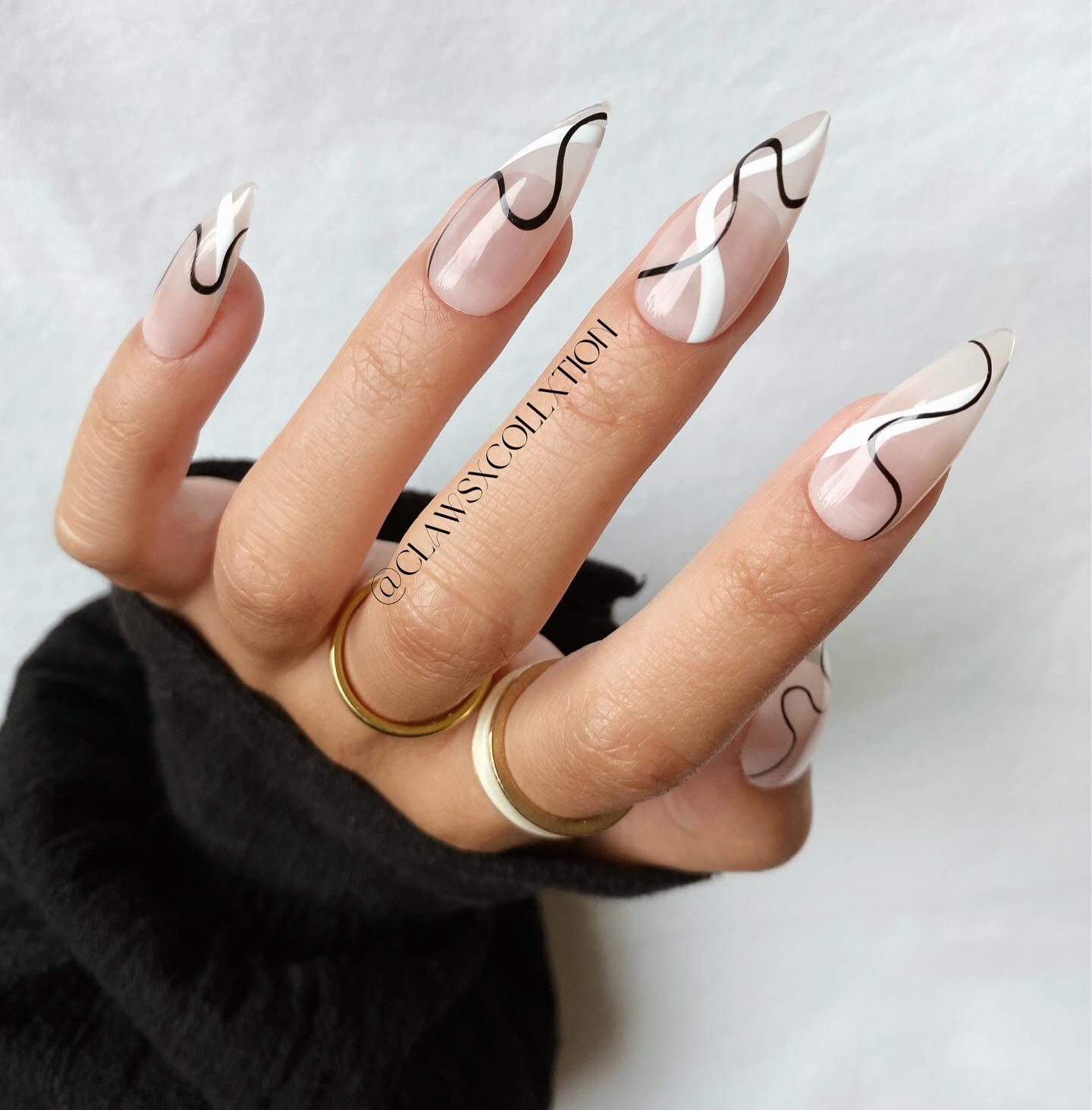 Clear stiletto nails with black and white swirls