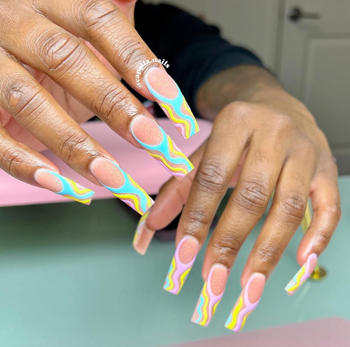 Pastel swirls with glitters on long square nails