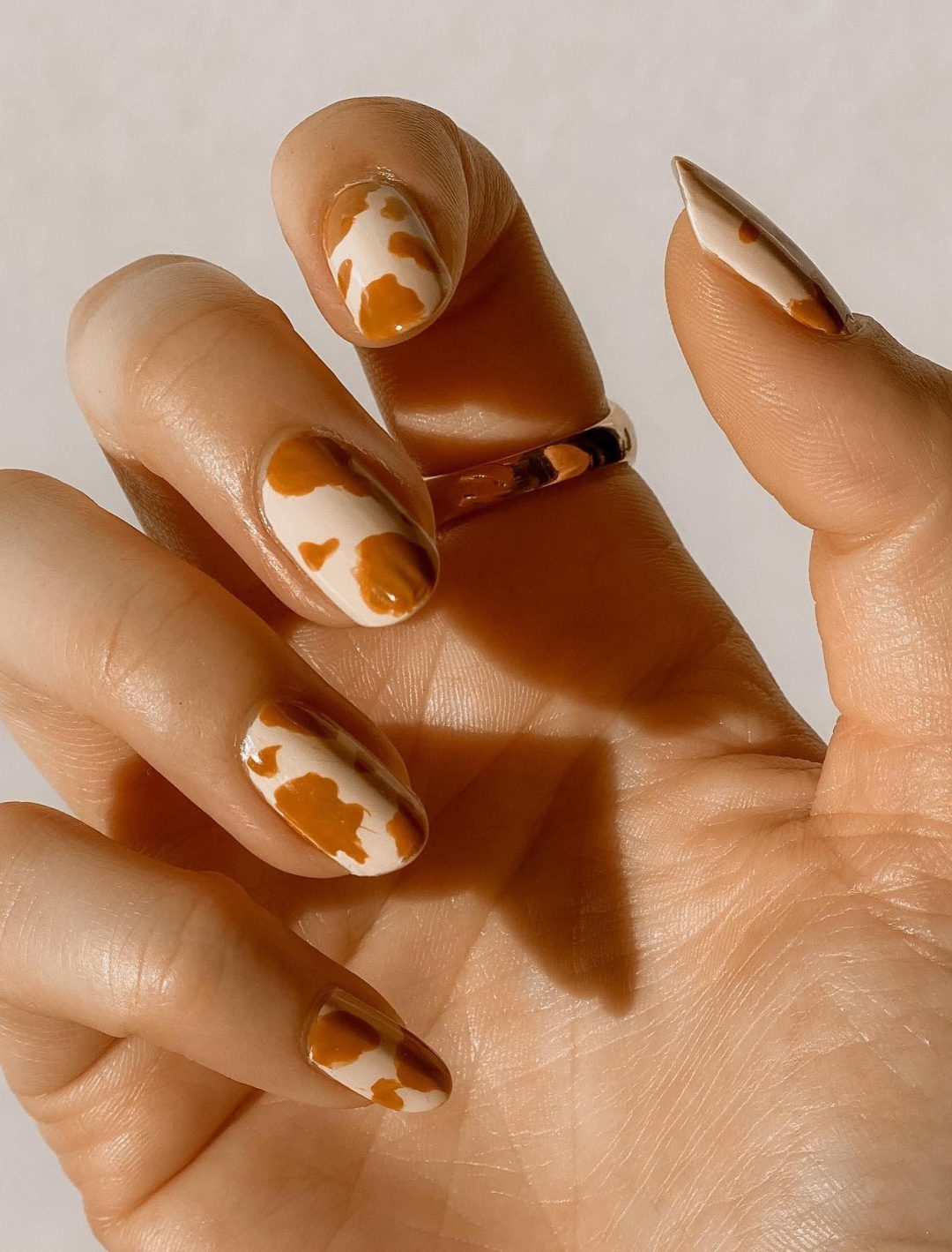 Brown cow print nails.