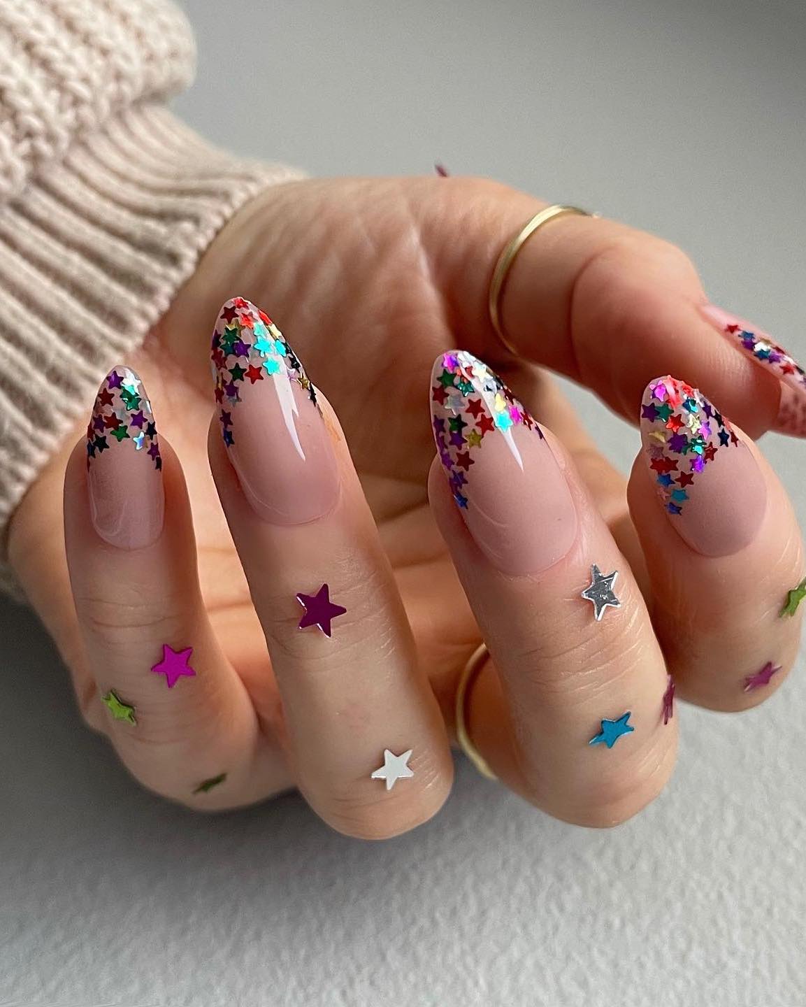 Glitter star French tip nails.