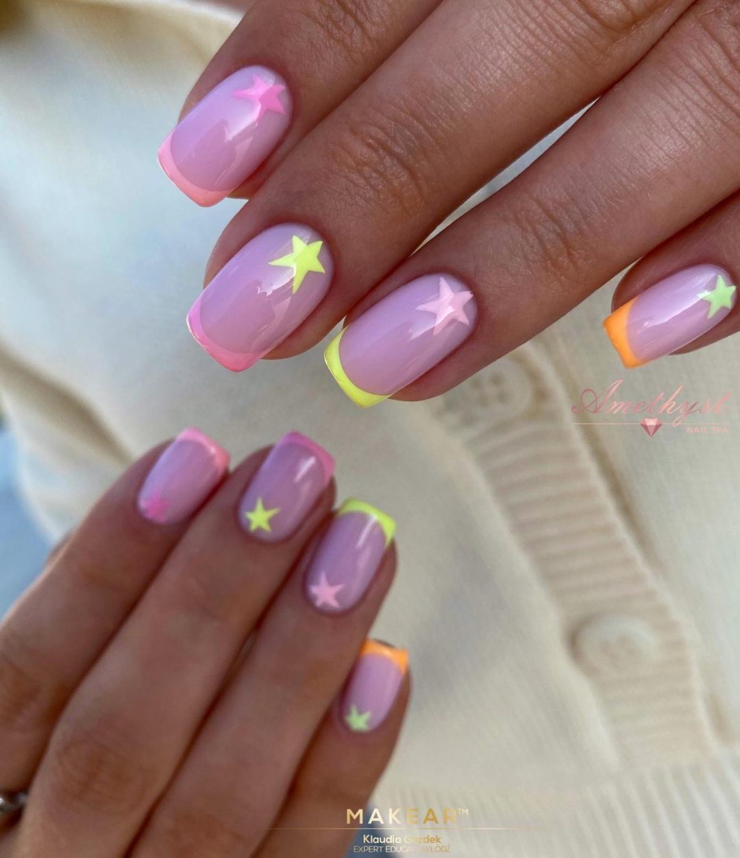 Pastel pink and neon yellow star nails