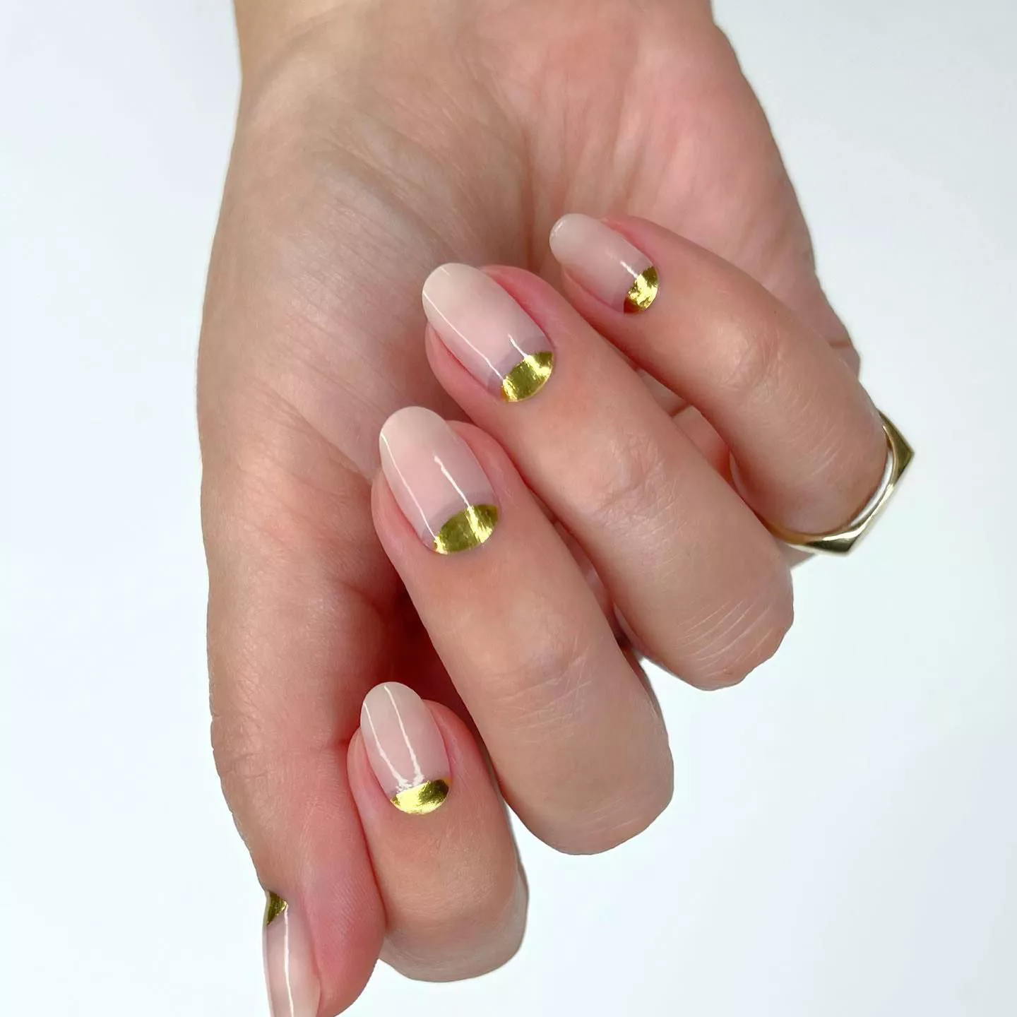 Manicure with gold polish on cuticle half-moon design