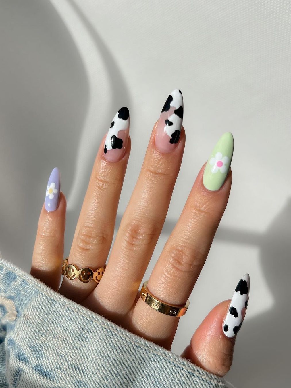 Cute pastel nails with cow print in almond shape.