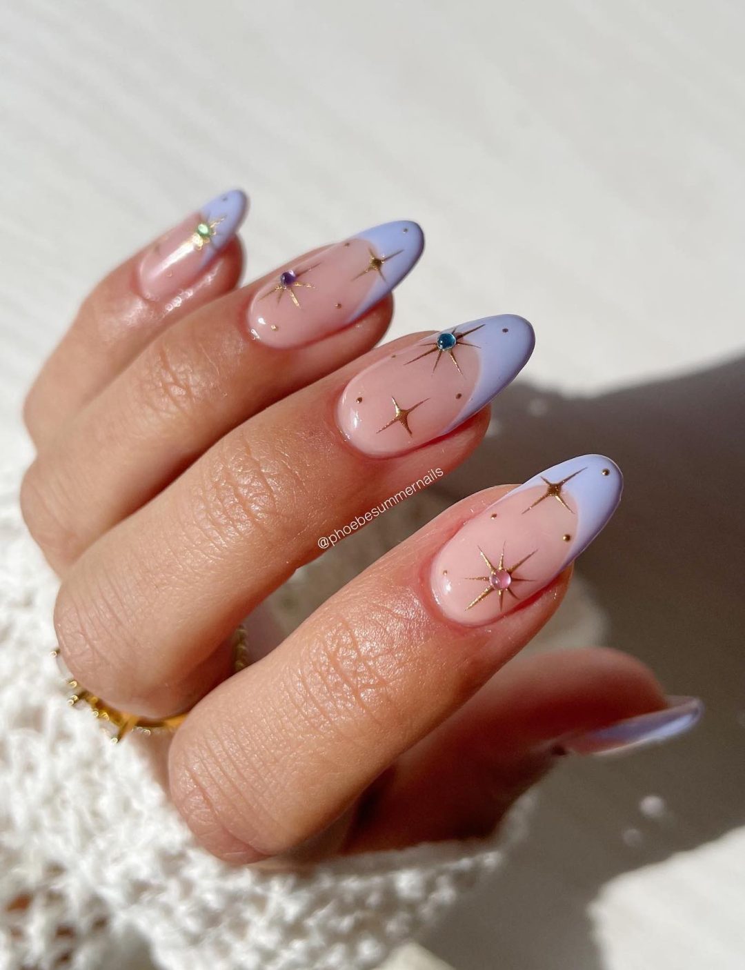Lavender French tip nails with star details.