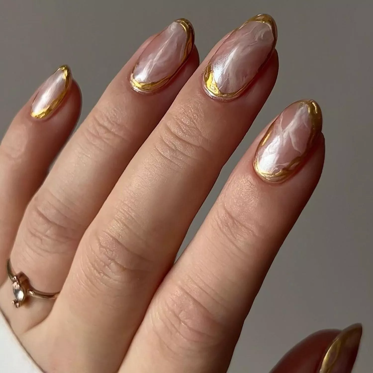 Chrome marbled nails with wavy gold border detailing