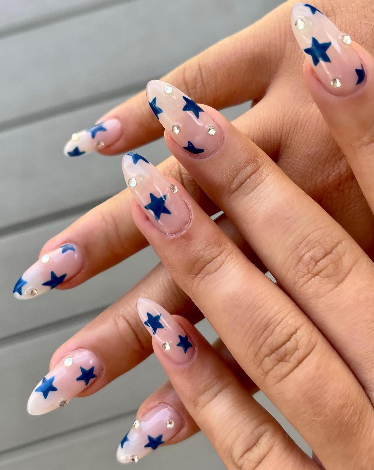 Blue star nails in almond shape.