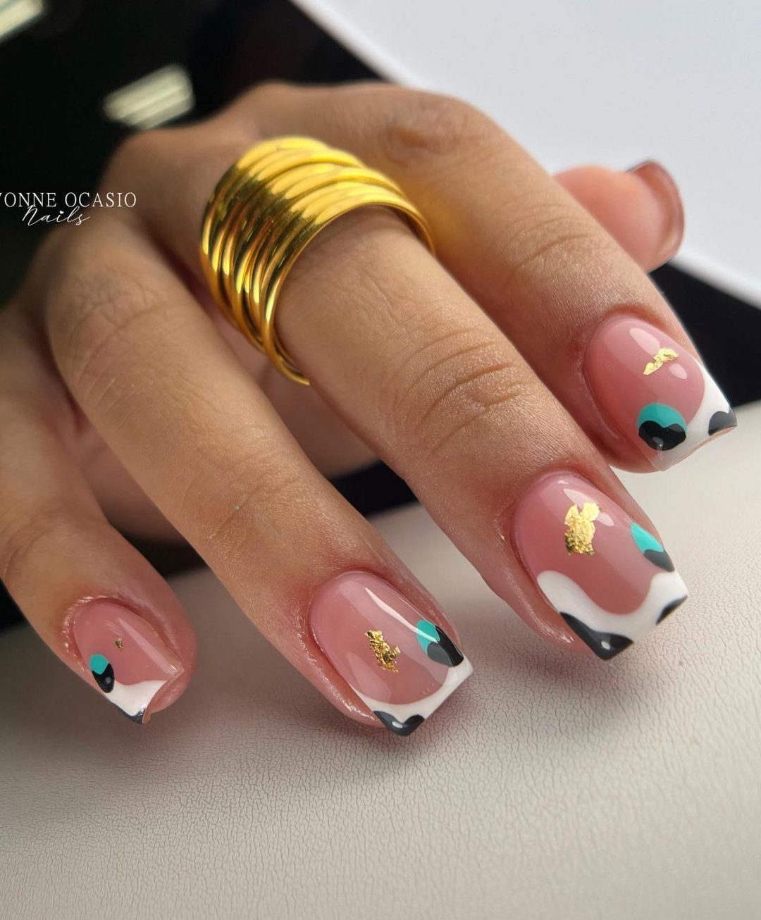 Chic cow print French tip nails.