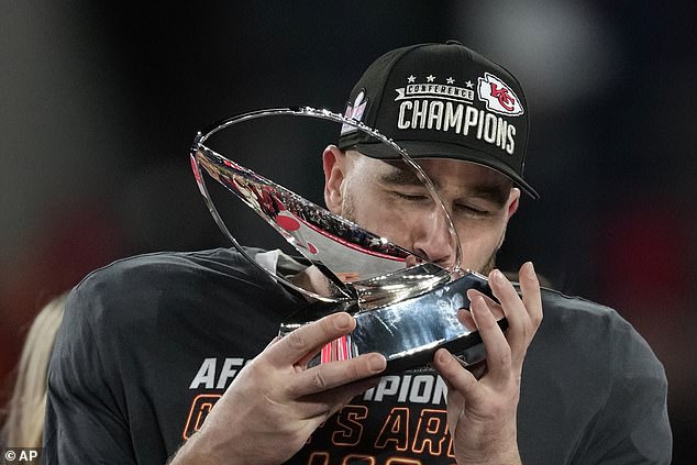 Kelce kisses the Lamar Hunt trophy as he commemorates a brilliant win for the Chiefs