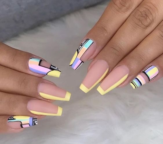 Long coffin acrylic nails with yellow abstract nail art