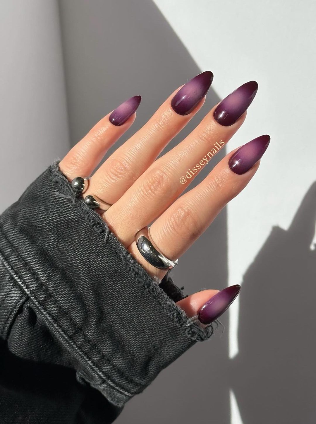 Dark purple aura nails.