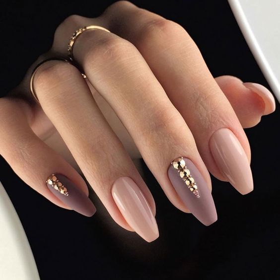 Neutral colors nail polish with gold bling on medium coffin nails