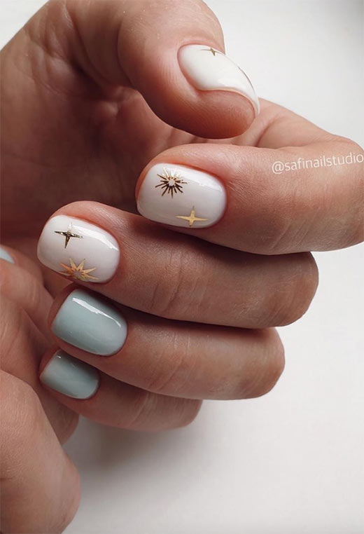 Powder blue and white nails with gold stars