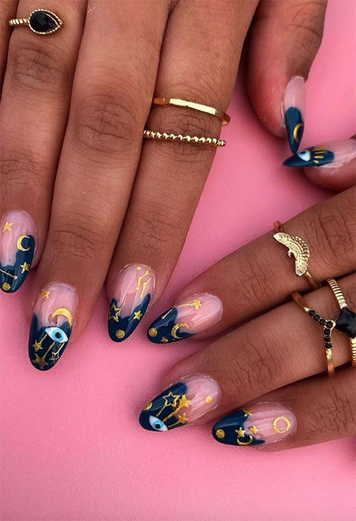 Clear nails and blue wavy tips with gold decals