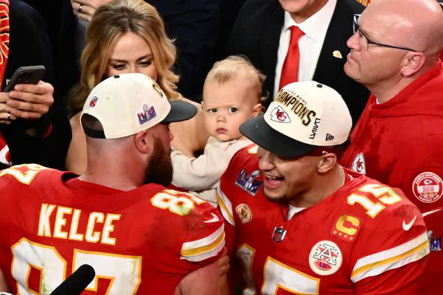 <p>PATRICK T. FALLON/AFP via Getty</p> Kansas City Chiefs' quarterback #15 Patrick Mahomes (R) speaks to Kansas City Chiefs' tight end #87 Travis Kelce as his wife Brittany Mahomes holds his son Patrick Bronze after the Chiefs won Super Bowl LVIII against the San Francisco 49ers at Allegiant Stadium in Las Vegas, Nevada, February 11, 2024.