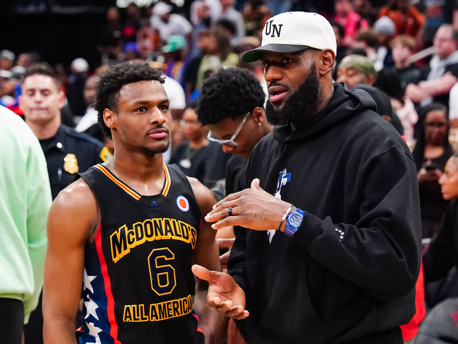 Bronny James #6 of the West team talks to Lebron James of the Los Angeles Lakers after the 2023 McDonald's High School Boys All-American Game