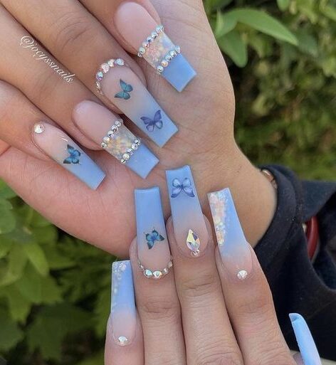 Baby blue ombre nail art with blue butterflies and stones on long square nails