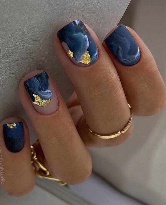 Matte finish dark blue marble nail art with gold foil on short square nails