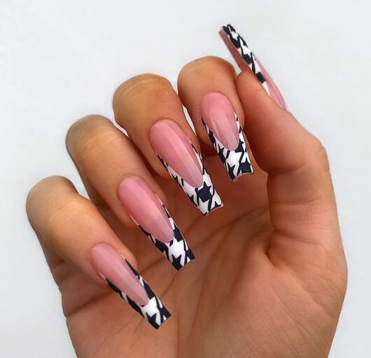 Black and white geometric nail art French tips on long coffin nails