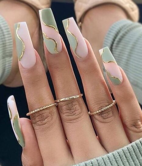 Light green swirls with gold outline on long square nails