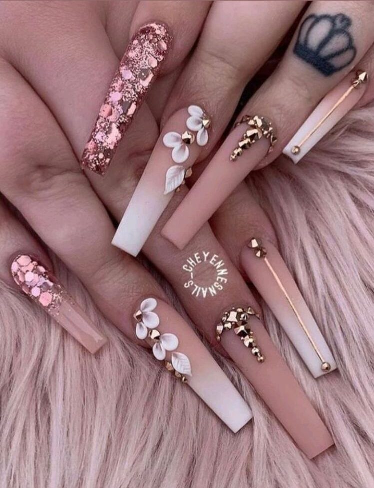 Nude to white ombre effect with 3D white flowers, gold bling, and pink glitters on super long coffin nails