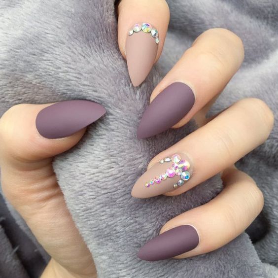 Beige and purple nail polish in matte finish with rhinestones on medium stiletto nails