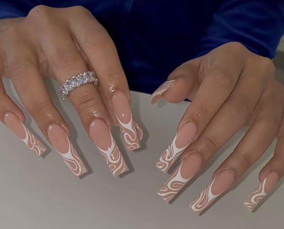 Long clear acrylic nails with white swirls on the tips