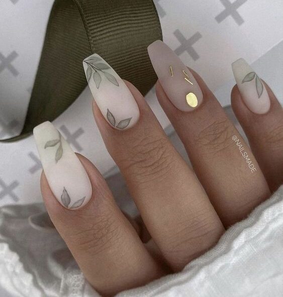 Matte white acrylic nails with leaves and gold nail art