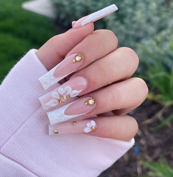 Long square acrylic nails with white glittery French tips and 3D flowers