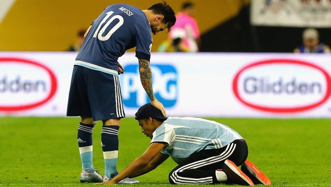 Messi puts his hand on the fan's head as he bowed.