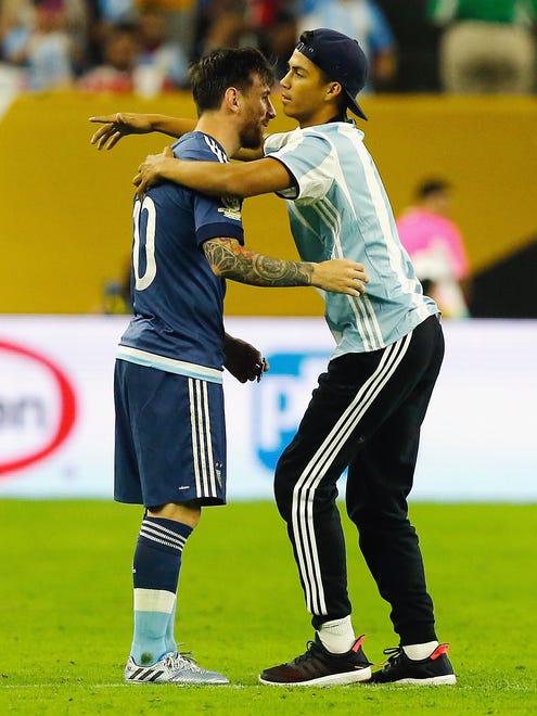 Messi opened his arms for the fan as the two begin to embrace each other.