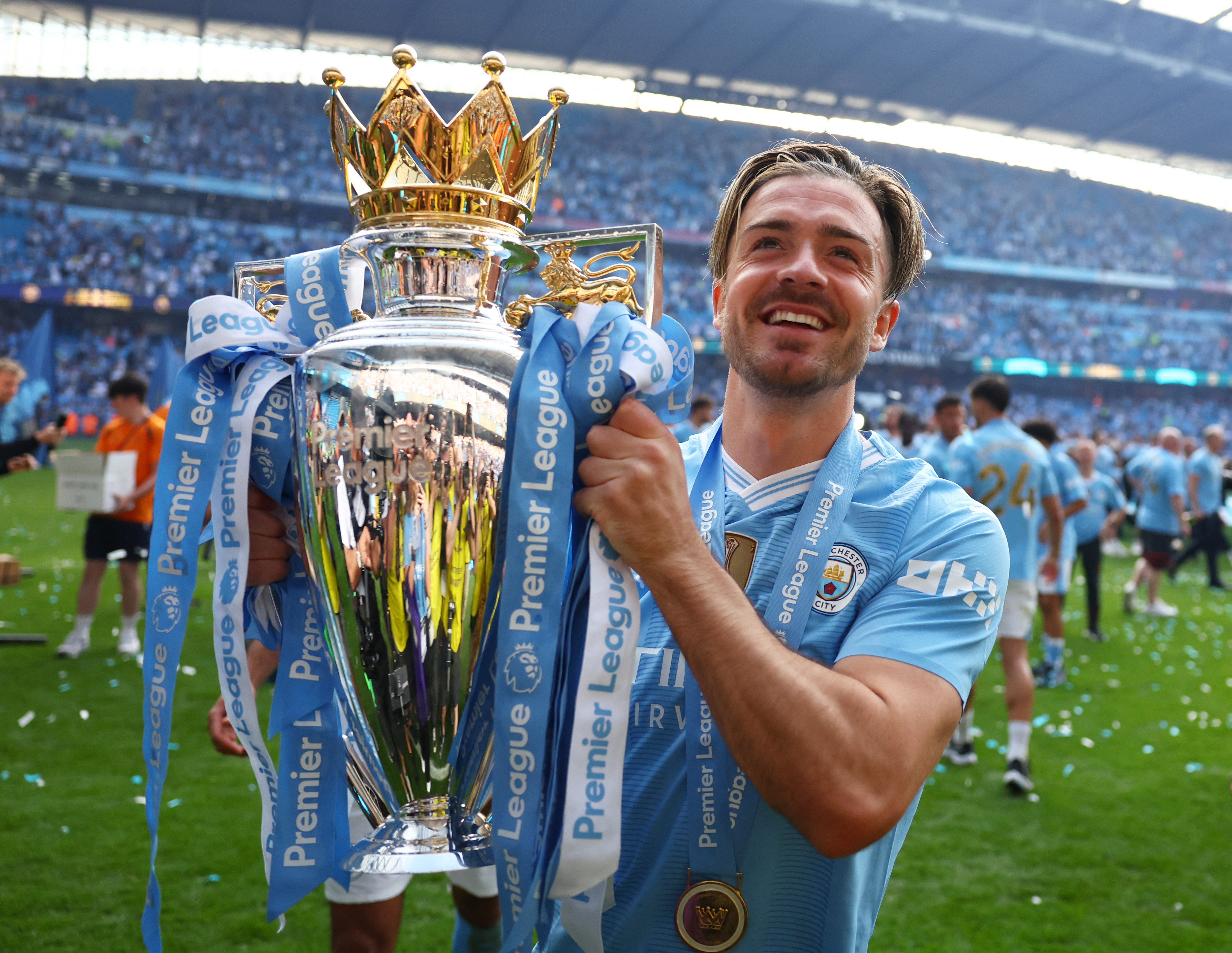 Jack Grealish beams with the trophy