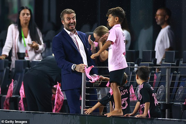 The Argentine's two eldest sons were frolicking about on the sideline following a rain delay