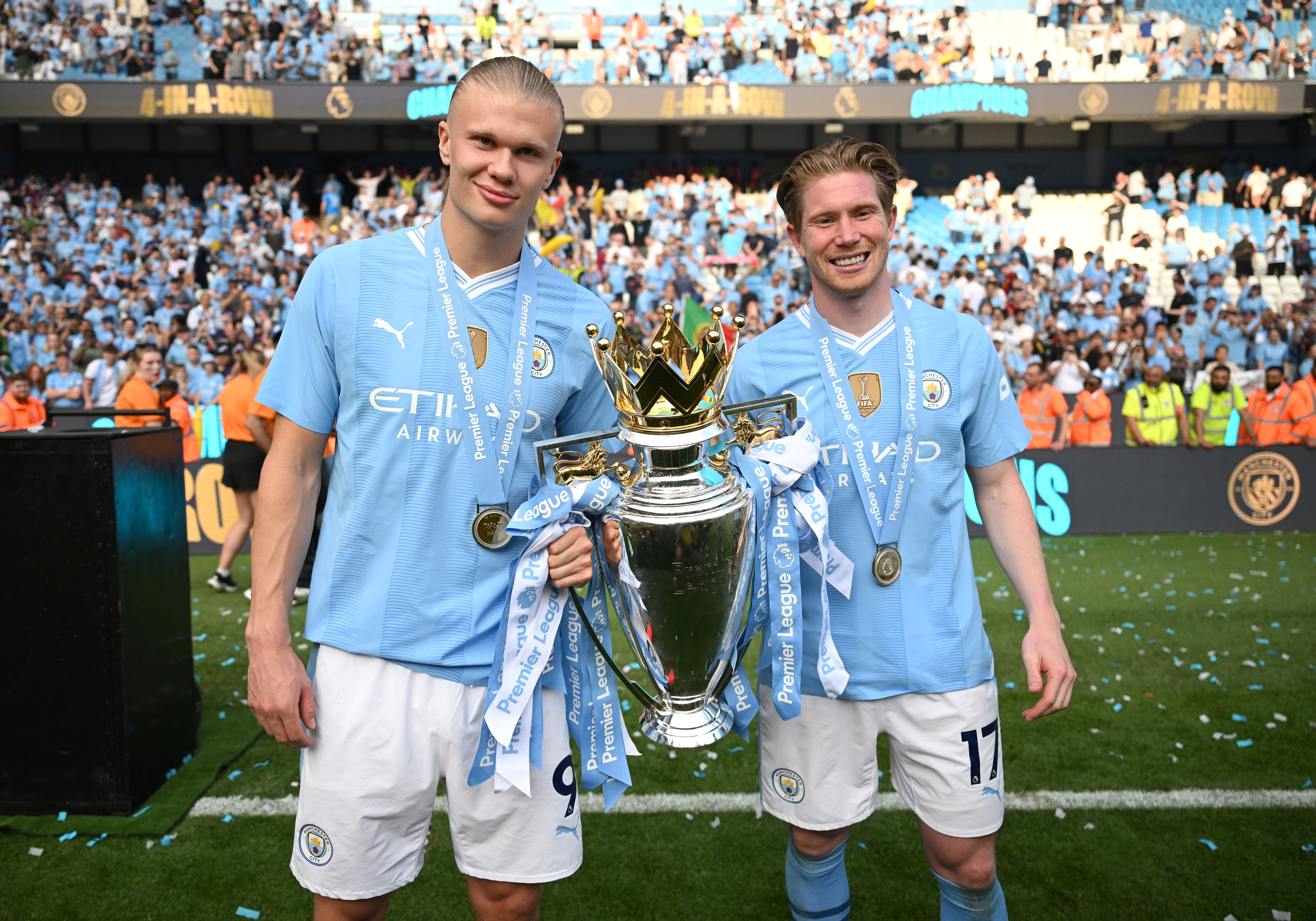 Erling Haaland clutches the Prem trophy with Kevin De Bruyne