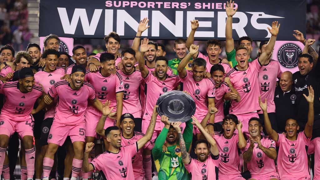 Oct 19, 2024; Fort Lauderdale, Florida, USA; Inter Miami CF goalkeeper Drake Callender (1) (middle) and defender Sergio Busquets (5) (left) and forward Lionel Messi (10) (right) raise the supporters shield post game against the New England Revolution at Chase Stadium. Credit: Sam Navarro-Imagn Images